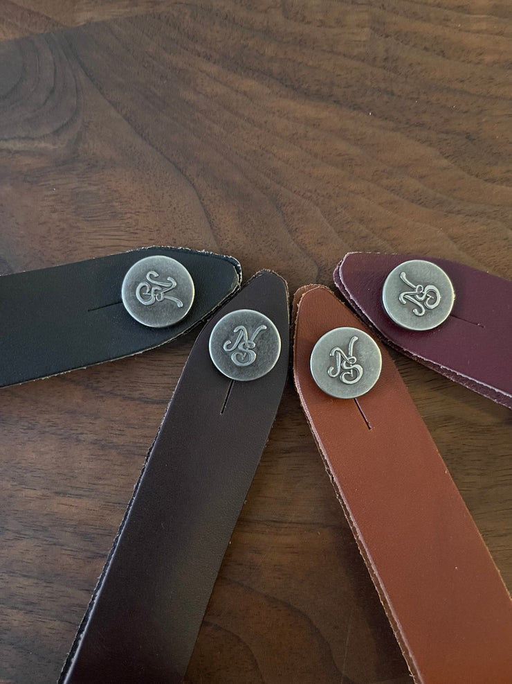 Native Sons Goods leather guitar headstock adapter straps in black brown tan and maroon with metal button closures