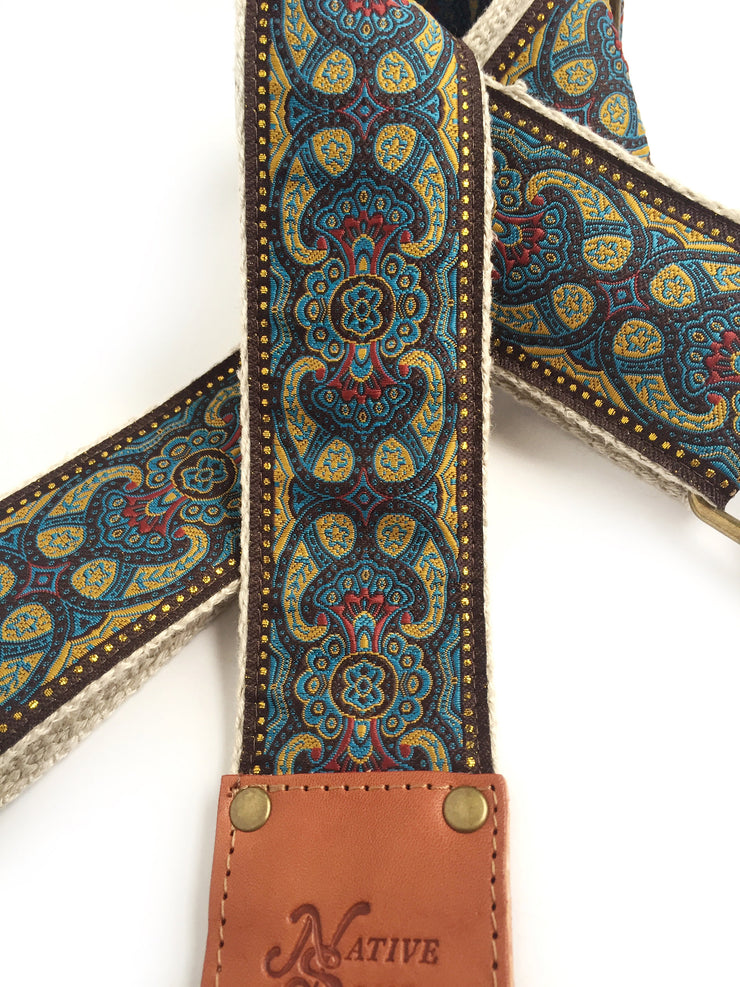 Native Sons Goods vintage style guitar strap with intricate blue and gold pattern and leather ends